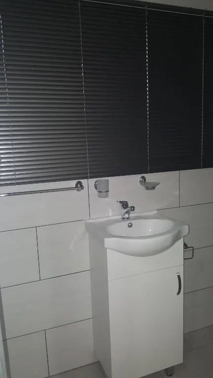 Modern bathroom with white vanity sink and mirrored cabinet above