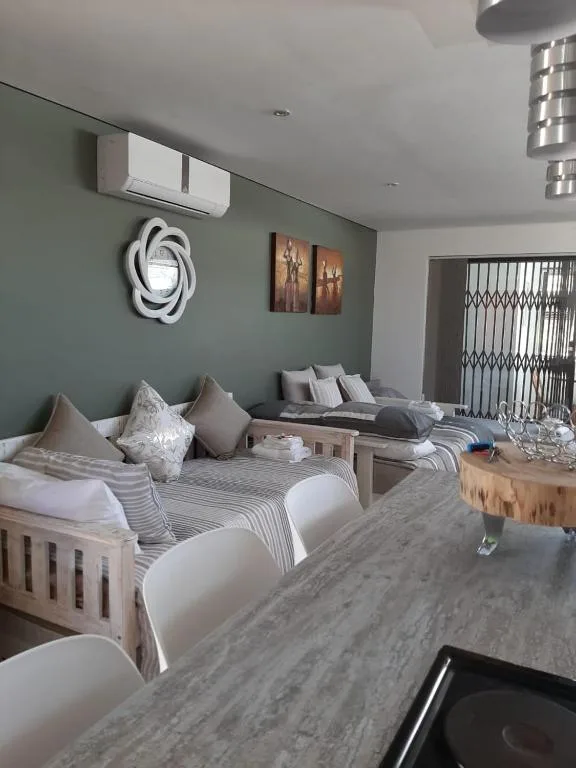Modern bedroom with twin beds, grey accent wall, and contemporary decor