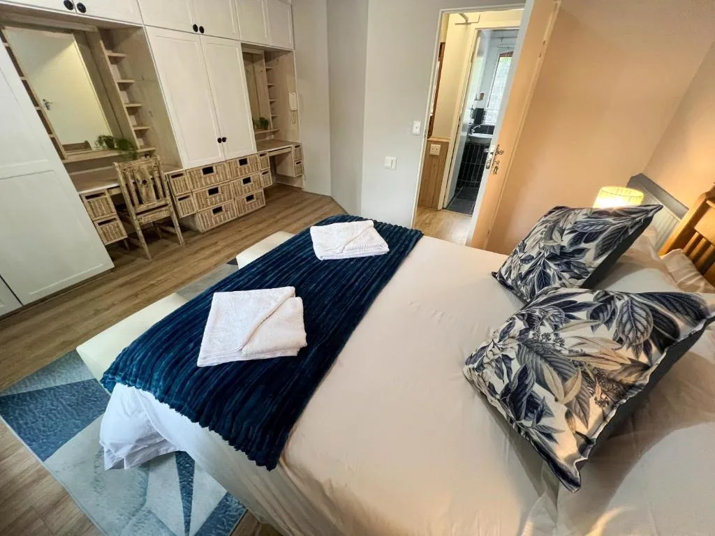 Spacious bedroom with queen bed, twin beds, built-in wardrobes and storage.