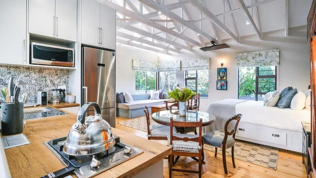 Open-plan kitchen with stainless steel appliances and wooden countertops