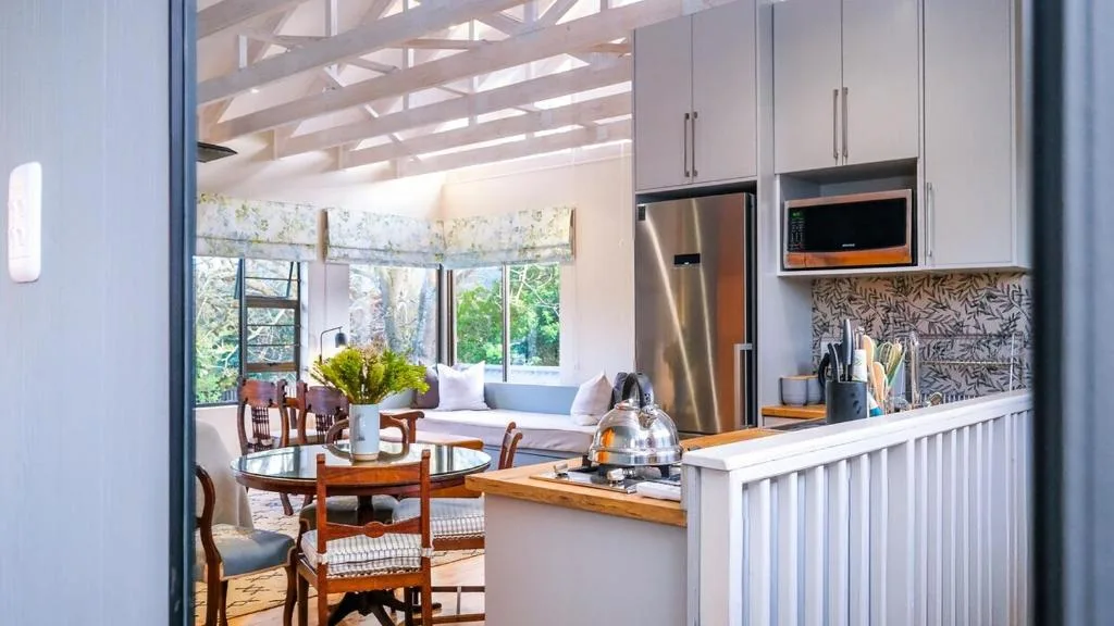 Modern kitchen with stainless steel appliances and patterned backtile