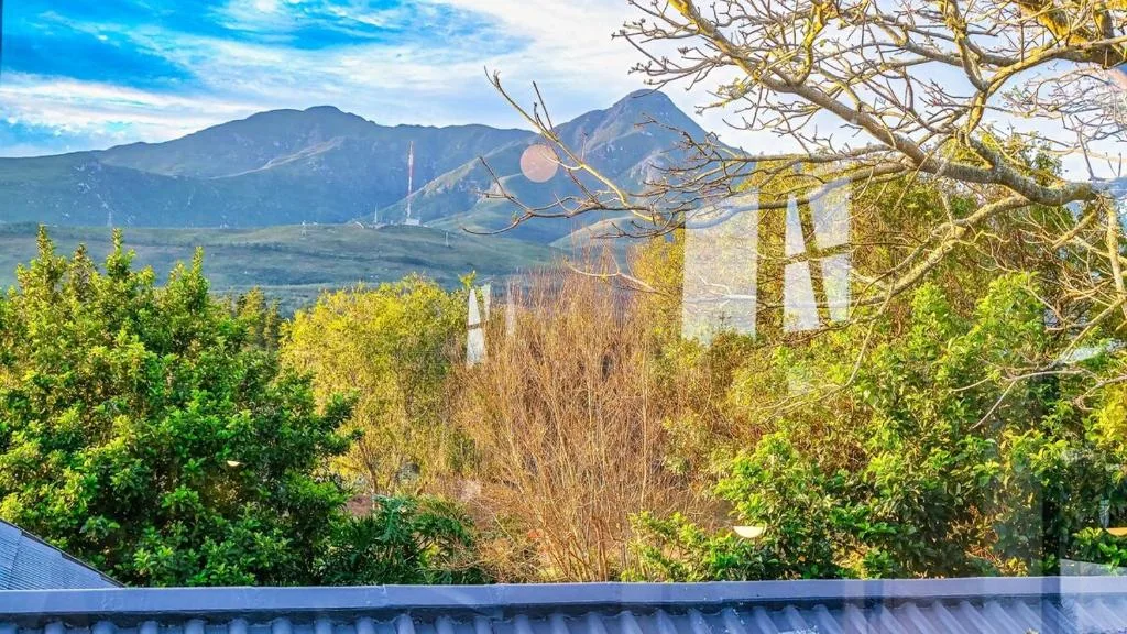 Mountain landscape vista with distant peaks and lush green valley