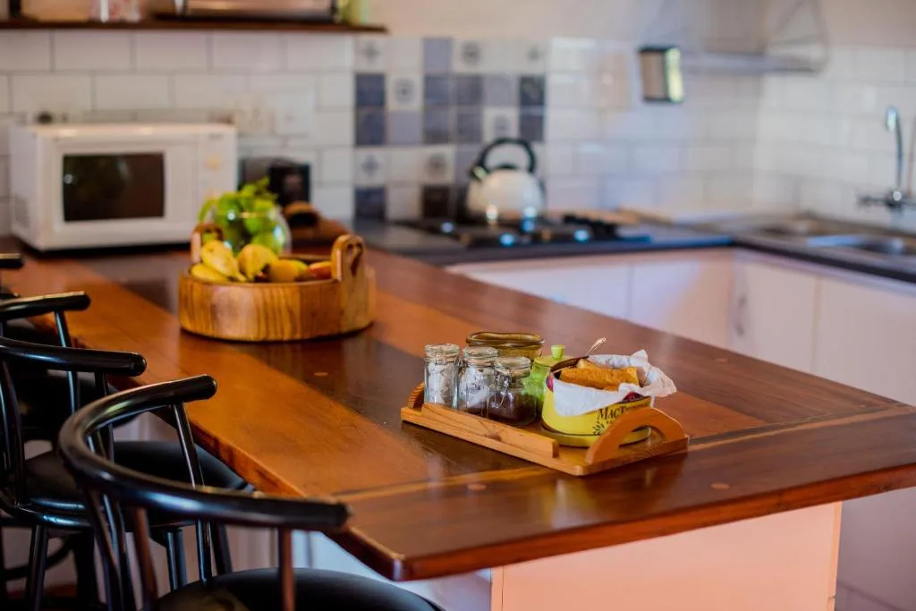 Modern kitchen with wooden countertop, fresh fruit bowl, and stainless steel appliances