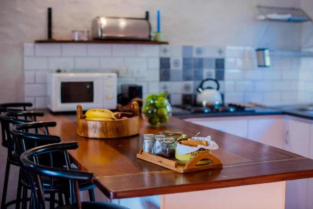 Modern kitchen with wooden countertop, microwave, and fresh fruit displayed