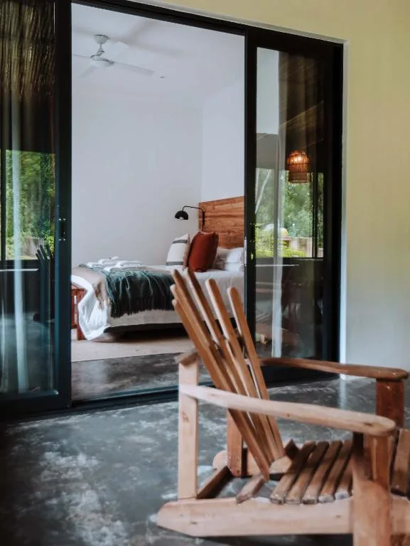 Wooden bed with red accents visible through glass doors from deck