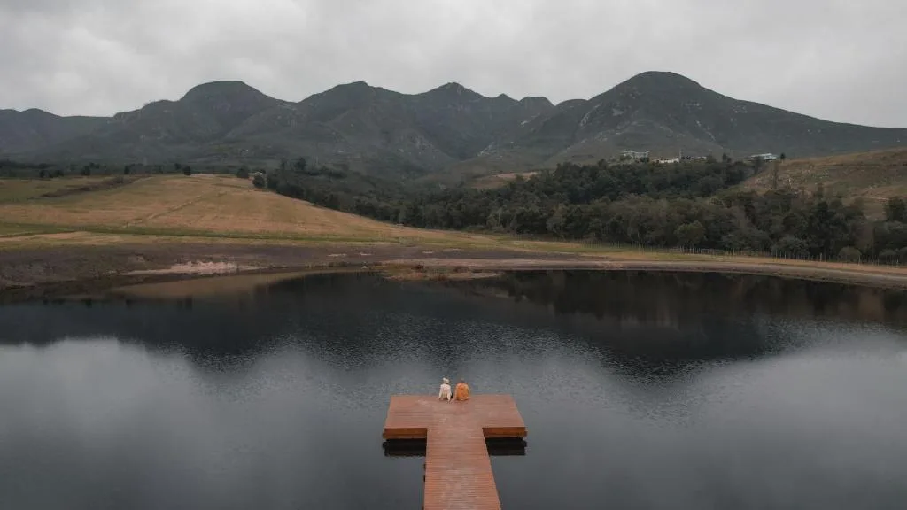 Mountain landscape with private dock extending into still water