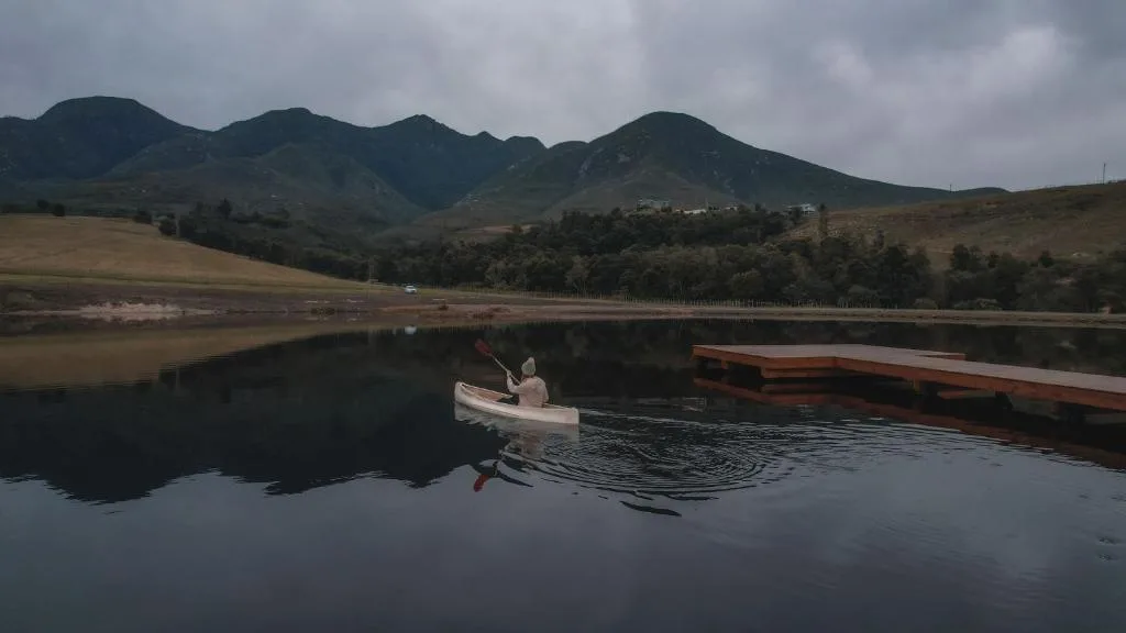 Scenic mountain landscape with tranquil lake and moored boats