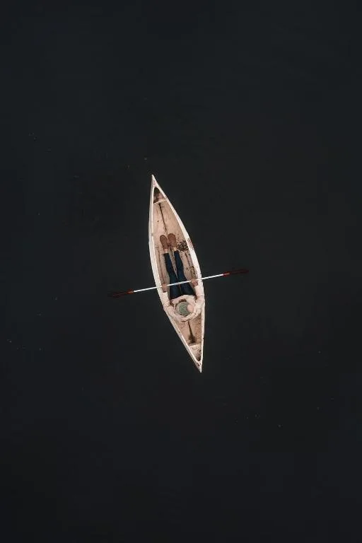 Aerial view of a small boat on dark water near the property