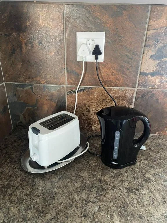 White toaster and black electric kettle on kitchen counter
