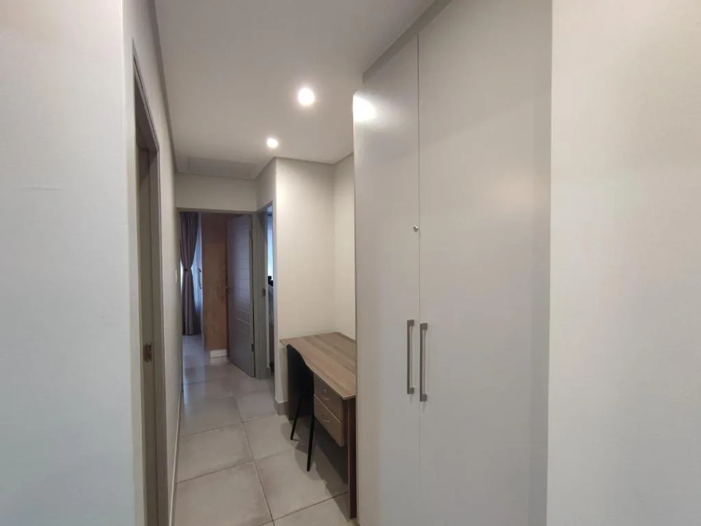 Modern hallway with built-in wardrobes and desk vanity area