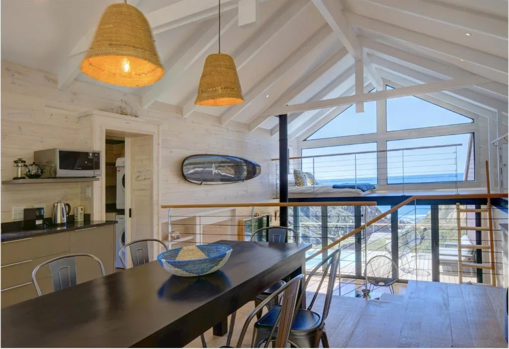 Modern dining area with ocean views and pendant lighting overhead