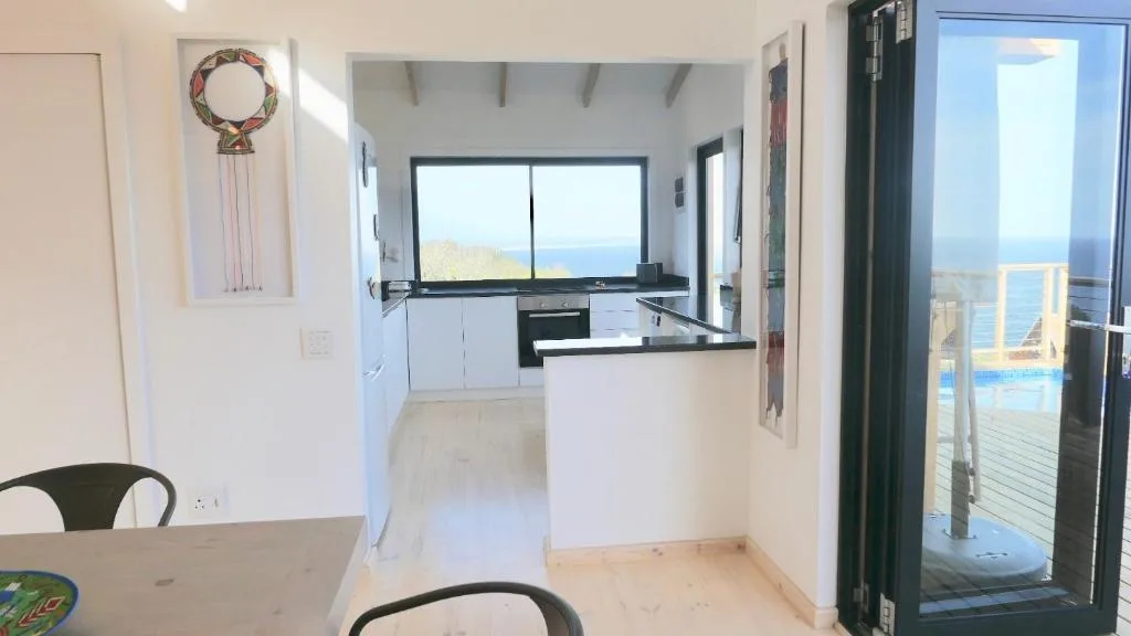 Modern open-plan kitchen with ocean views through large windows