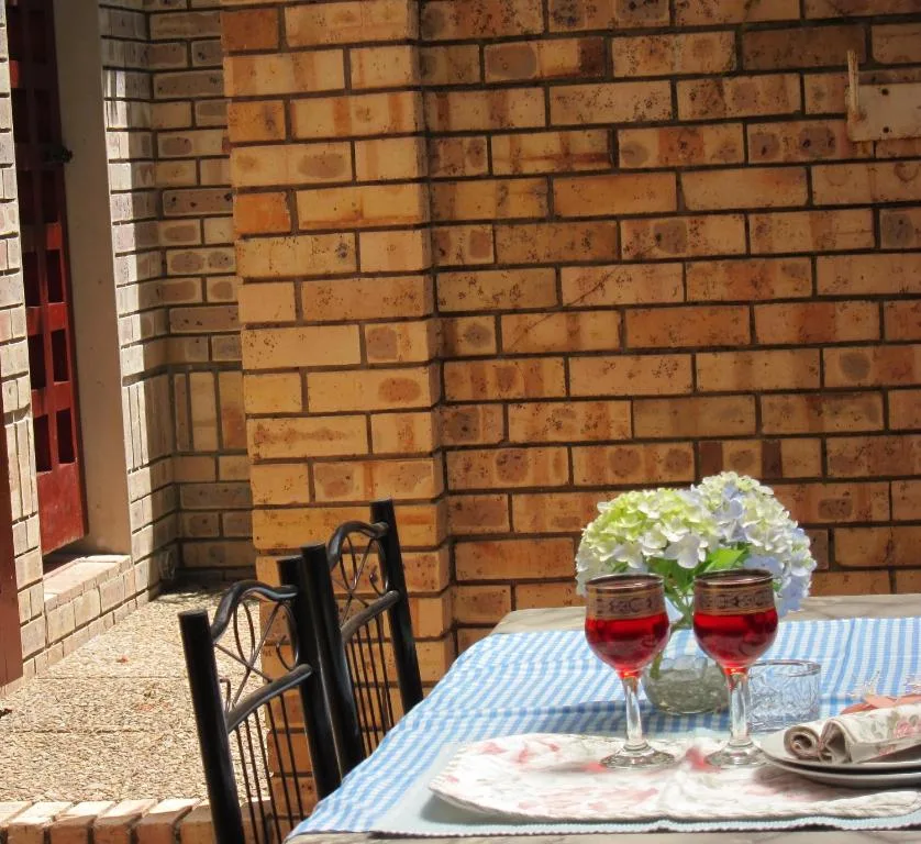Outdoor patio with dining setup against brick building wall