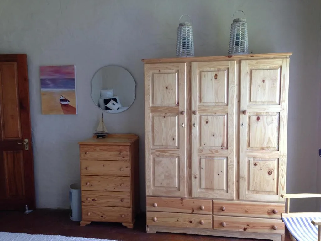 Spacious bedroom with pine furniture, wardrobe, and coastal decor accents