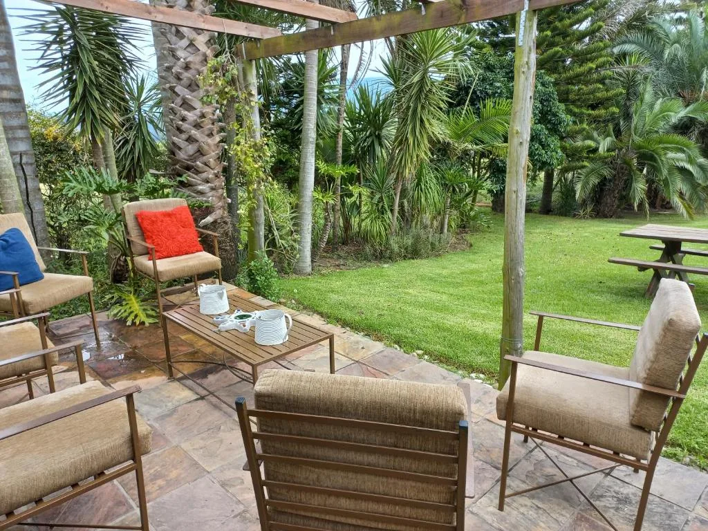 Covered patio with comfortable seating and lush tropical garden views