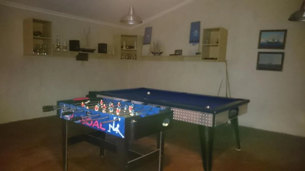 Game room with foosball table and pool table for entertainment