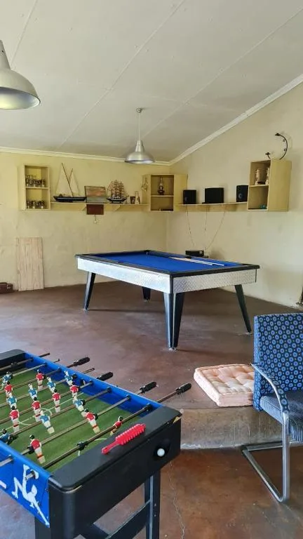 Games room with pool table, foosball, and comfortable seating area