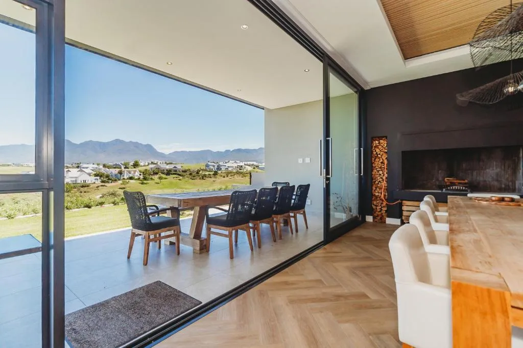 Modern patio with dining table overlooking mountains and valley landscape