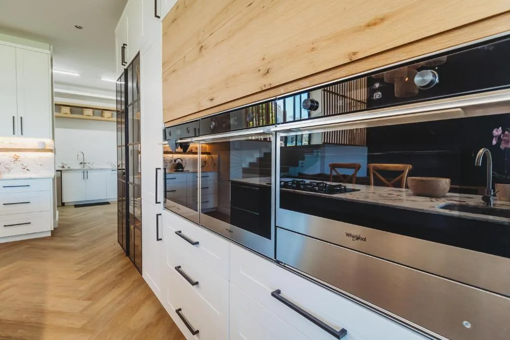 Modern kitchen with stainless steel appliances and white cabinetry