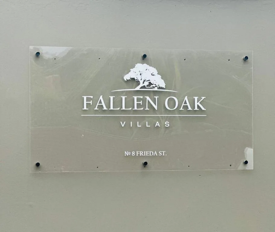 Fallen Oak Villas property sign mounted on exterior wall