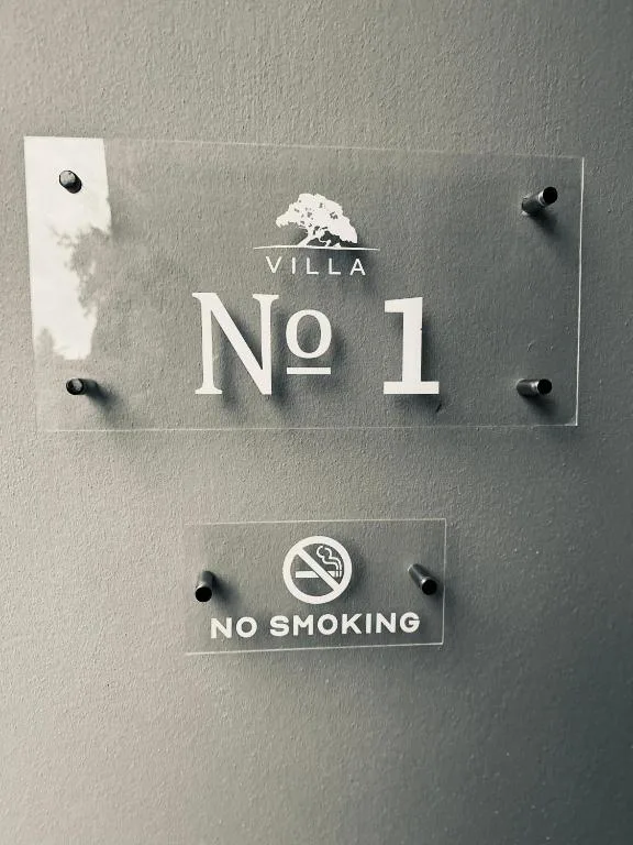Property entrance sign reading Villa No 1 with no smoking symbol