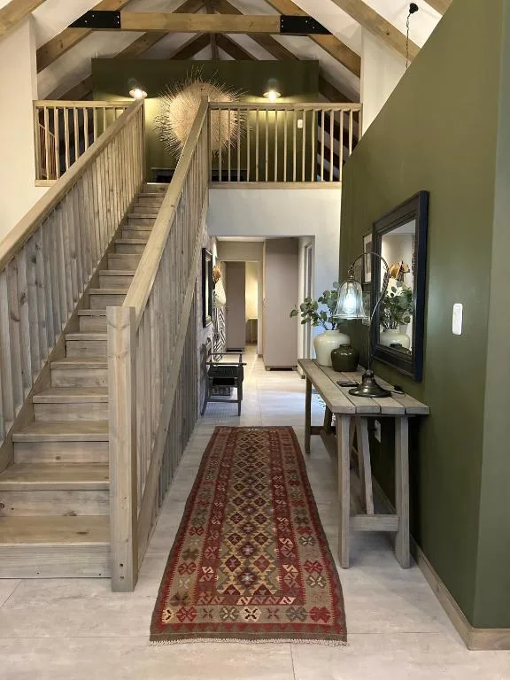 Modern entrance hall with wooden staircase and decorative console table