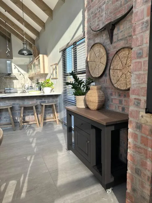 Decorative woven baskets and plant arrangement on black cabinet shelf