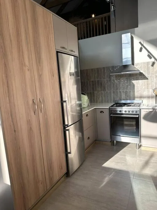 Modern kitchen with stainless steel appliances and wood cabinetry