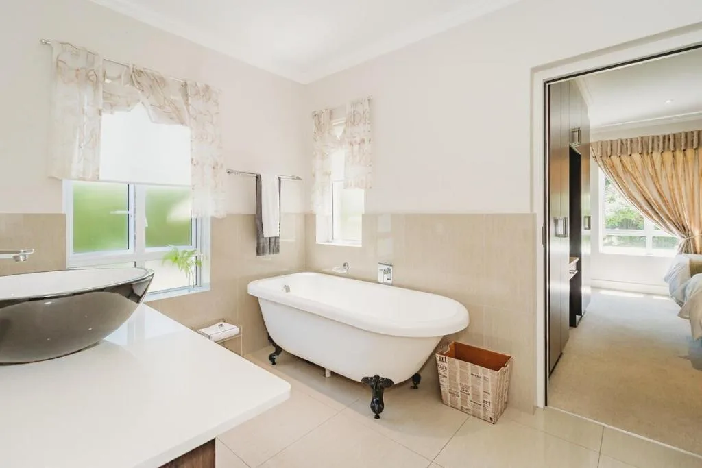 Spacious bathroom with freestanding bathtub and double vanity sinks