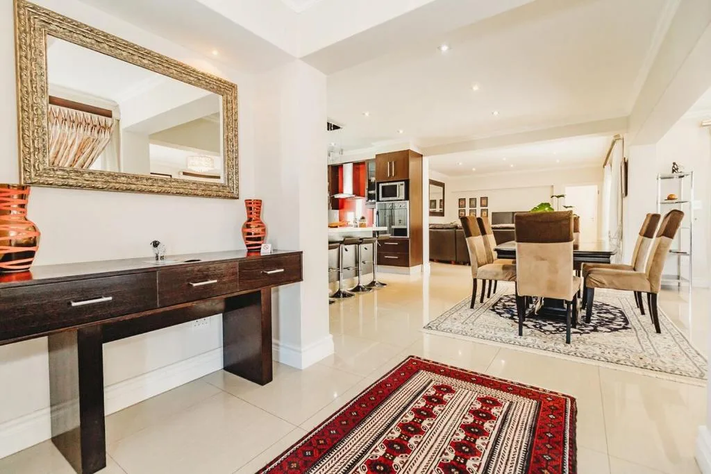 Spacious open-plan lounge with modern furnishings and decorative accents