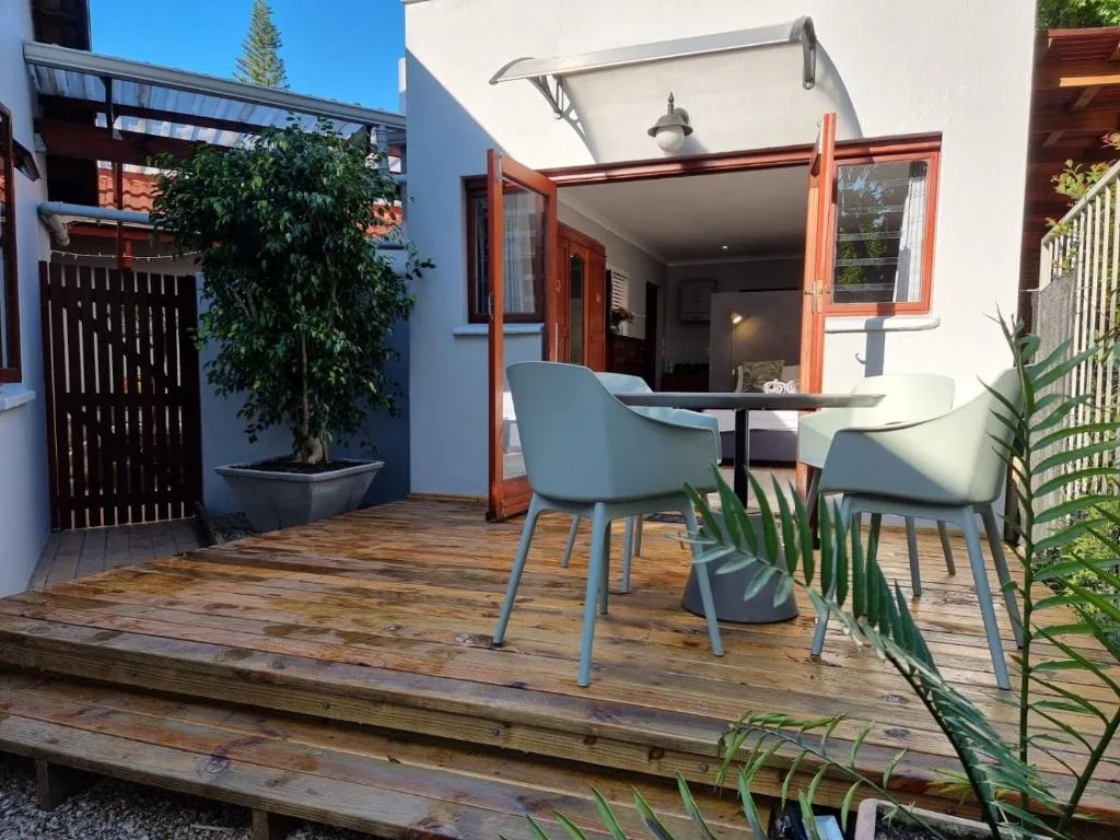 Wooden deck with modern seating area and garden access