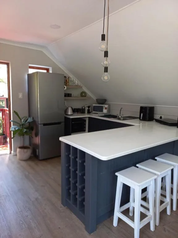 Modern kitchen with island counter, bar seating, and stainless steel appliances