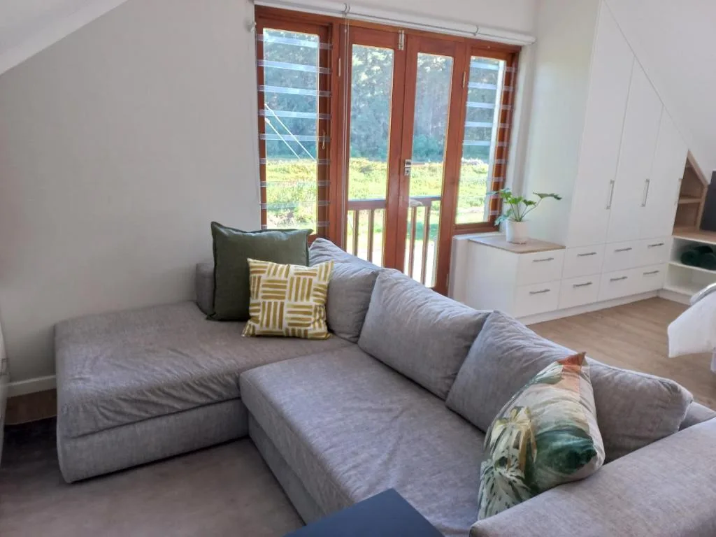 Modern gray sectional sofa with mountain views through wooden sliding doors