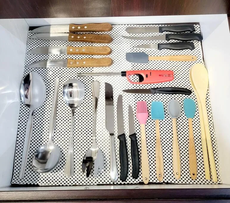 Complete kitchen utensil set organized in a drawer with knives and cooking tools