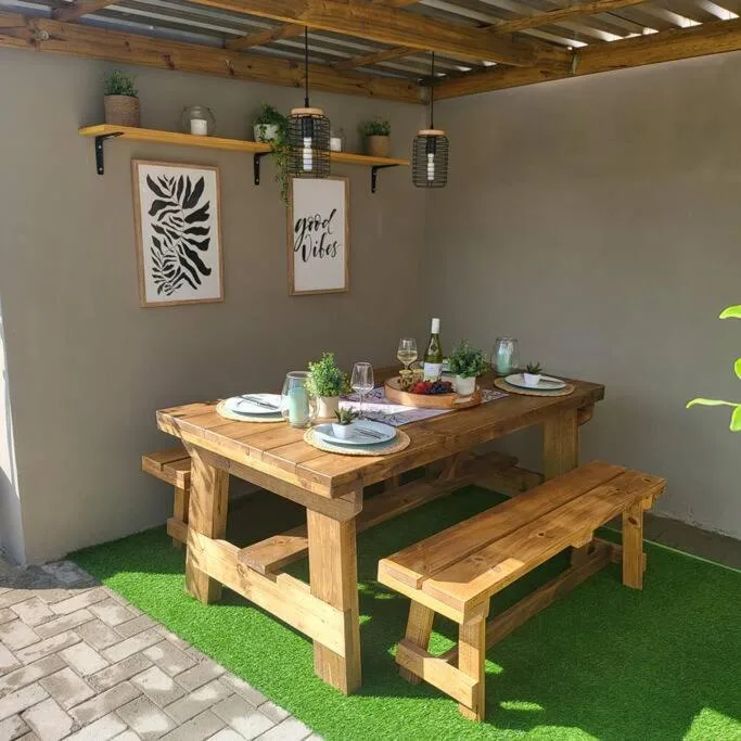 Rustic wooden dining table with bench seating and place settings indoors
