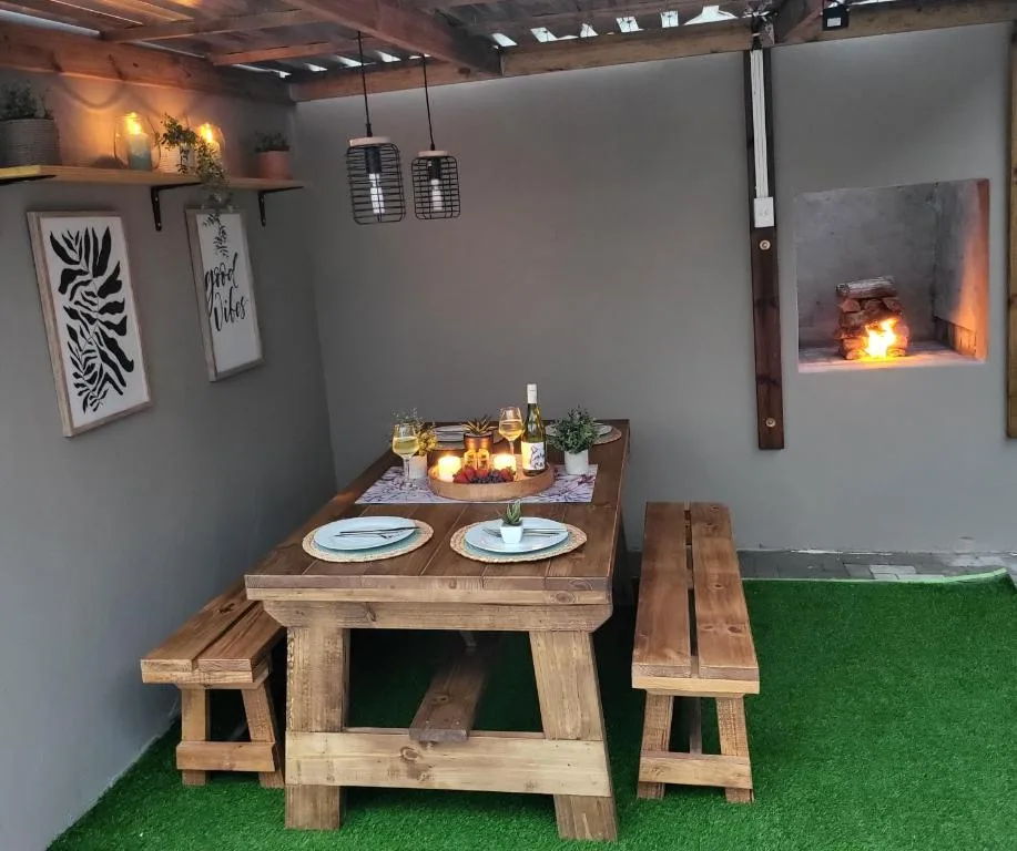 Intimate wooden dining table set for two with place settings and wine