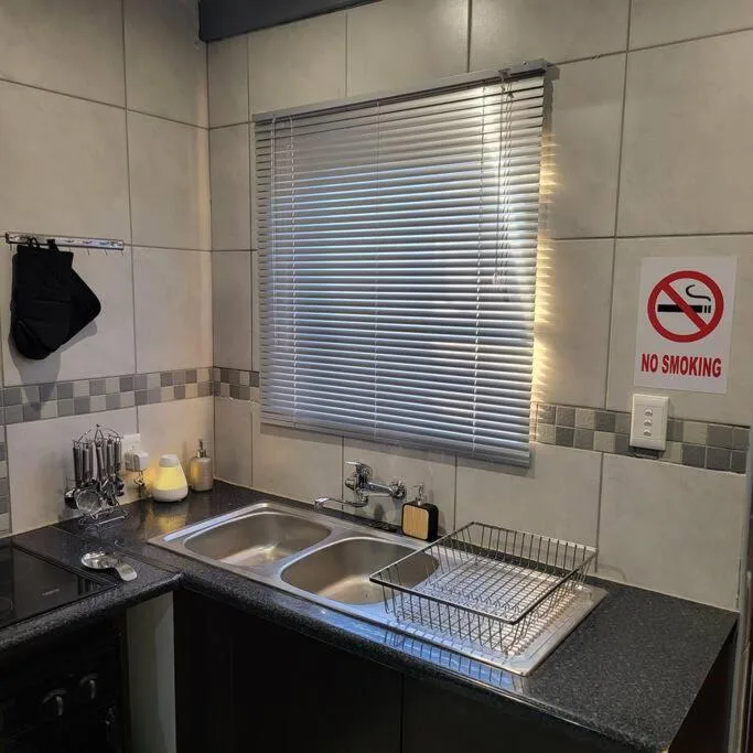 Kitchen sink with double basin and draining board under window