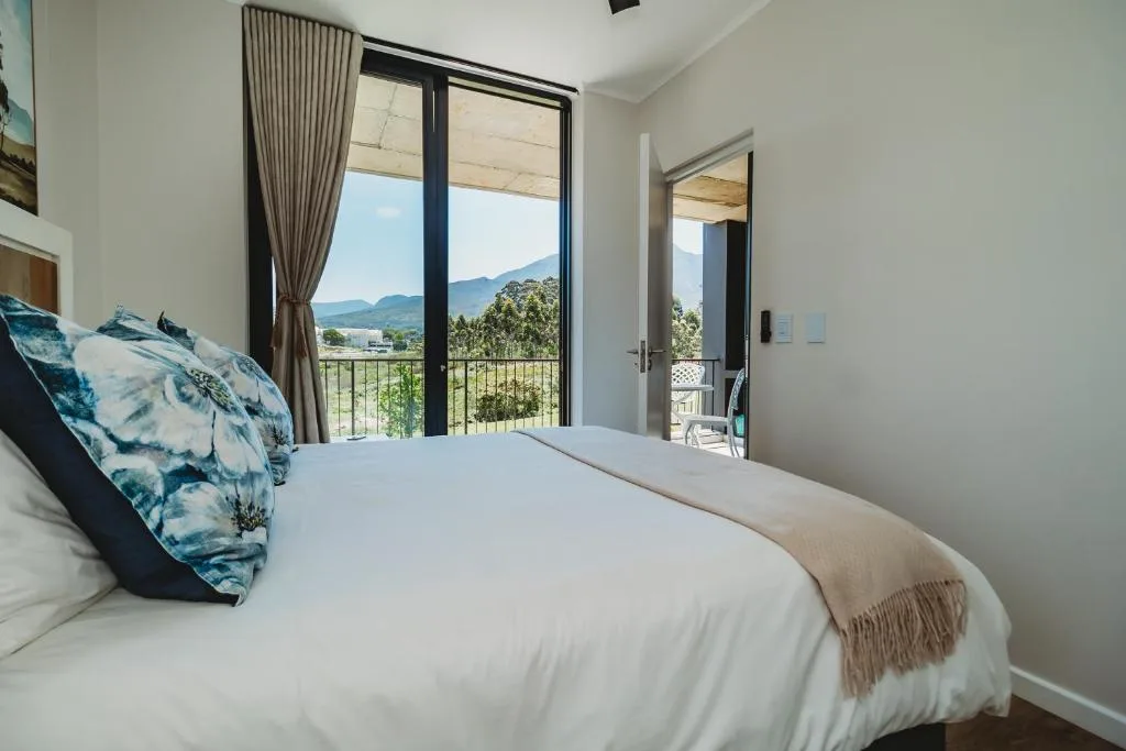 Bedroom with mountain views through large sliding glass doors and balcony