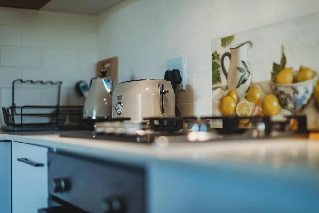 Bright kitchen counter with toaster, kettle, and fresh lemons in bowl