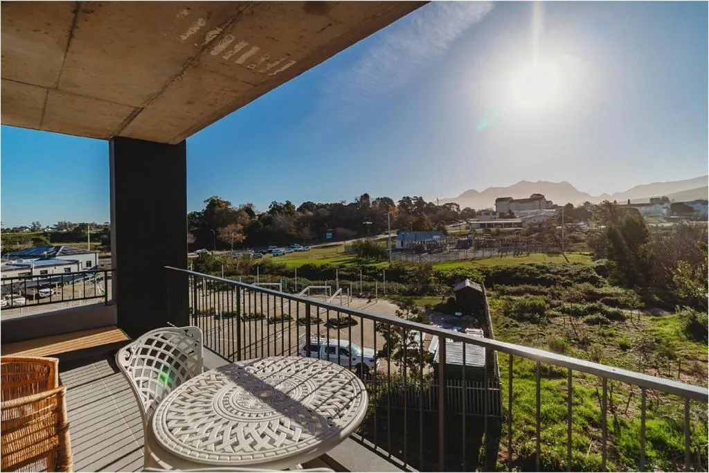 Mountain and valley landscape vista from covered balcony with seating