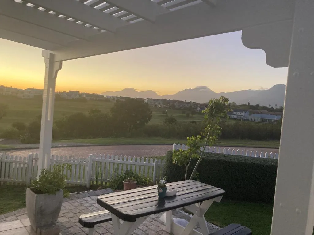 Sunset mountain vista from covered patio with rolling green valleys
