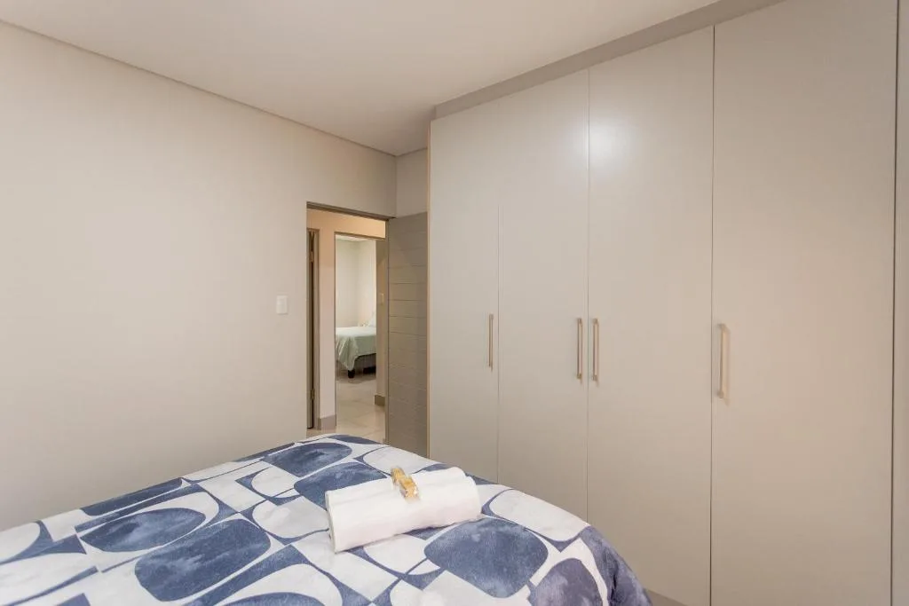Modern bedroom with double bed and built-in wardrobe storage