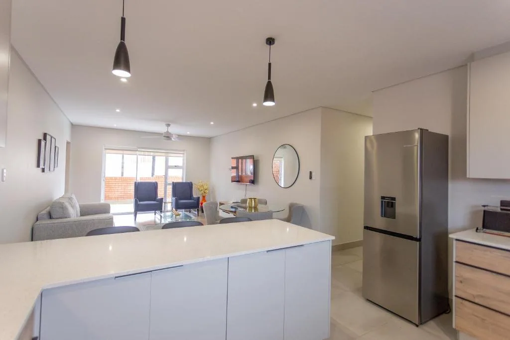 Modern open-plan kitchen with island bench and stainless steel appliances