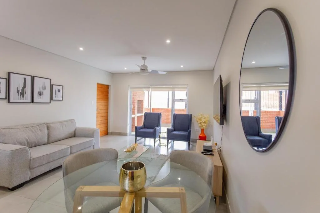 Modern lounge with gray sofa, dining table, and contemporary decor