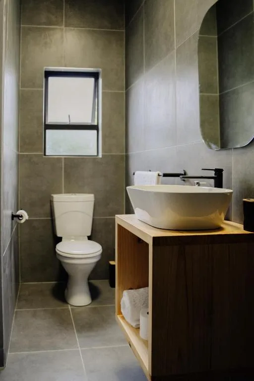 Modern bathroom with ceramic vessel sink and toilet fixtures