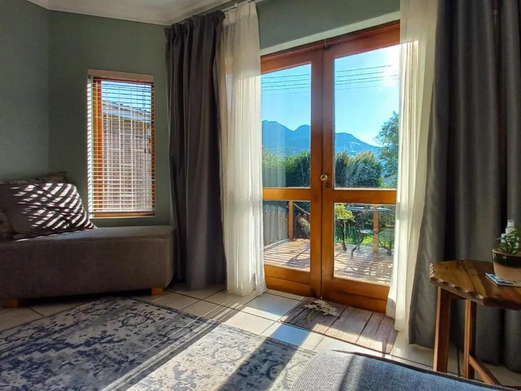 Bedroom with mountain view through French doors and window seating