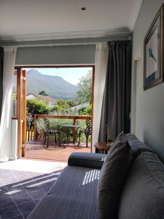 Bedroom with bed and open doors leading to mountain view deck