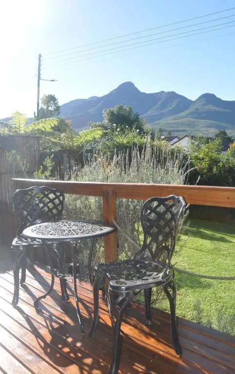 Wooden deck with table and chairs overlooking mountain views