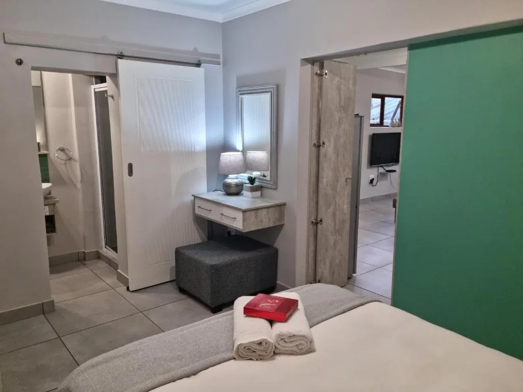 Modern bedroom with en-suite bathroom access and contemporary furnishings