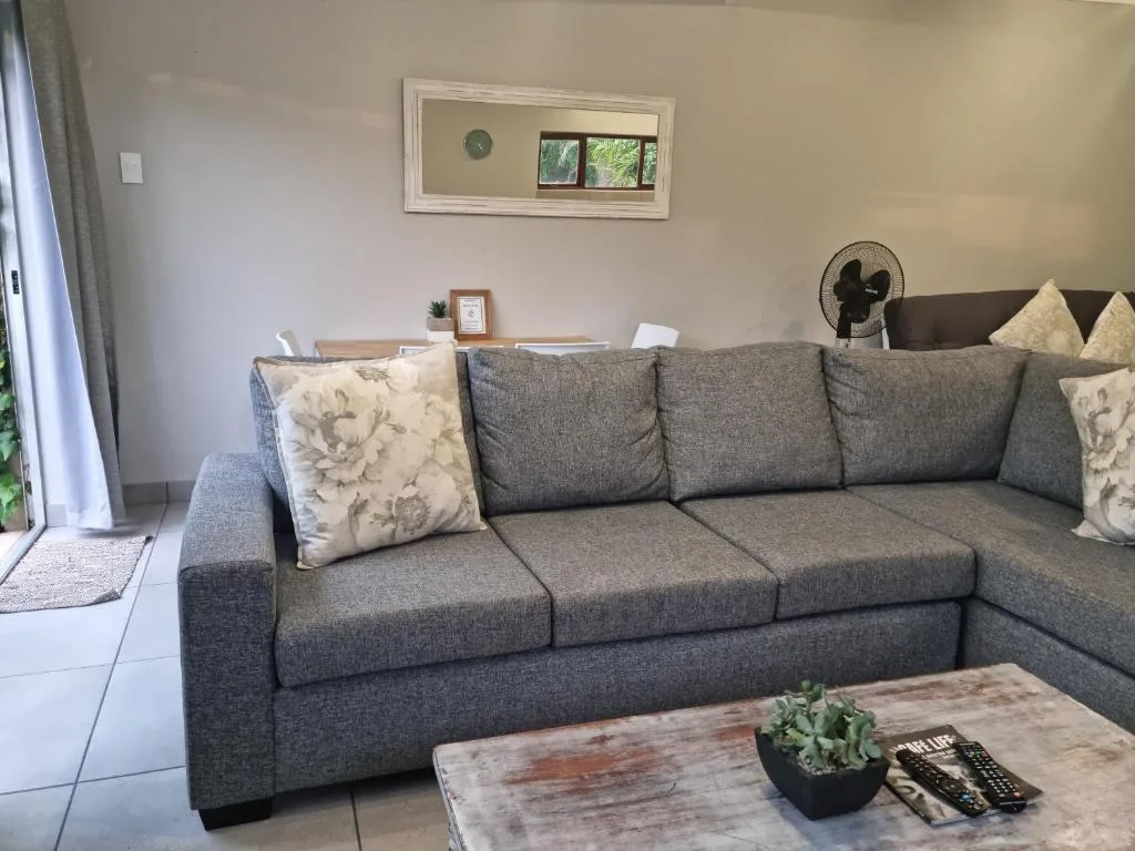 Modern gray sectional sofa with decorative pillows and coffee table